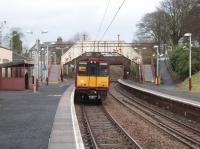 Neilston, now a terminus rather than a through station, has a country branch line atmosphere despite the overhead electrification and suburban EMUs. 314215 has used the shunting neck to cross over to the departure platform and is now waiting to head back to Glasgow.<br><br>[Mark Bartlett 26/02/2009]