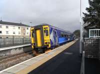 A 4-car 156 pulls into Stewarton on 17 March 2010. The train is heading for Kilmarnock where it will split for 2 return journeys to Glasgow.<br><br>[David Panton 17/03/2010]