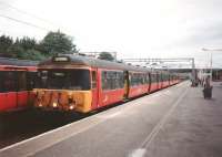 303 055, still with sliding windows, stands at Motherwell's 'via Blantyre' circle platform 3 on 1 June 1997.  This has to be a Sunday (and it was: I've checked) because the train is for Balloch, on other days a destination for North Clyde trains only<br><br>[David Panton 01/06/1997]