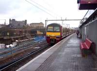 The 1608 Drumgelloch - Balloch service approaching Airdrie's platform 2 on 27 March 2010 with work underway in connection with the rebuilding of the eastbound through platform for use by future Bathgate/Edinburgh trains.<br><br>[John Steven 27/03/2010]