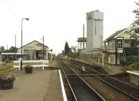 Looking south along the platforms at North Walsham station on 31 July 1996. The fencing of the Carless oil terminal is visible through the goods shed and the storage tower of the HP canning factory looms large to the right.<br><br>[David Pesterfield 31/07/1996]