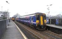 Passing at Livingston South - 156s in different obsolescent liveries depart more or less simultaneously with a Glasgow stopper (left) and an Edinburgh semi-fast on 24 March 2010<br><br>[David Panton 24/03/2010]