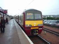 Balloch bound 320319 awaits departure from bay platform 1 at Airdrie on 27 March 2010. <br><br>[John Steven 27/03/2010]