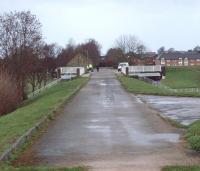 80 years to the day since its closure to passengers on 31st March 1930, this is the view west along the old GKER railway embankment east of Garstang towards the site of Garstang Town station. The station site itself has been built over. The railway bridge over the River Wyre was demolished after closure to goods in 1965 but a new bridge was installed as part of the water treatment and flood defence scheme seen here. My grandfather used to catch the <I>Pilling Pig</I> from Garstang Town to Garstang & Catterall to go to school in Lancaster but this was never a convenient journey for local residents and direct buses along the A6 later put paid to the train service. <br><br>[Mark Bartlett 31/03/2010]