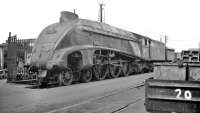 The rebuilt version of Gresley's infamous W1 no 10000, now renumbered 60700, stands at Doncaster works on what may have been its final visit, thought to be 24 May 1959. The locomotive, originally dubbed the <I>Hush-Hush</I> due to the number of experimental features incorporated, was the only 4-6-4 tender locomotive ever to run in Britain. After a problematic career the W1 was cut up here the following month.<br><br>[K A Gray 24/05/1959]