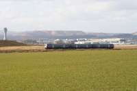 A Waverley-bound DMU heads south from The Forth Bridge past Edinburgh Airport on 17 March 2010 near the site of the former Turnhouse station (closed September 1930). The Grand Canyon - like backdop is based on leftovers from the West Lothian shale oil industry.<br><br>[John Furnevel 17/03/2010]