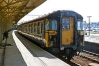 In their original form, the Class 309 'Clacton' EMUs had attractive wraparound windscreens, but they offered drivers little protection against impacts from bricks and other missiles that vandals were apt to hurl at trains in the 1970s. The windows were remodeled, detracting from the overall appearance, in the late 1970s. Shown here is an unrebuilt example waiting to leave Clacton on 3rd July 1977. [See image 40041]<br><br>[Mark Dufton 03/07/1977]