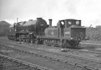 Terrier 0-6-0T no 32678 standing alongside Lord Nelson 4-6-0 no 30857 <I>Lord Howe</I> in the shed yard at 70D Eastleigh in October 1962.<br><br>[K A Gray 30/10/1962]