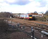 Behind the points paraphernalia at this busy junction the tracks seem almost incidental. To the left is the line to Dunfermline and the western half of the Fife Circle; the incoming Outer Circle service, formed by 170 474 in SPT livery (by no means unusual in Fife) would have passed that way over an hour previously. In the distance a Dundee semi-fast accelerates away from its Inverkeithing stop on the climb to Dalgety summit. March 2010.<br>
<br><br>[David Panton 27/03/2010]