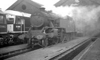 The changing scene at St Margarets shed in September of 1966, the year before official closure. Outside the now roofless section of the shed stands Fairburn 2-6-4T no 42128 which had been reallocated here from Hamilton three years earlier and would survive for a further six months or so before its final journey to Campbells of Airdrie at the end of November. Alongside on the left stands part of the 'new order' in the form of Type 2's D5062 and D5094, which had been moved north from Finsbury Park to Haymarket earlier that same year.<br><br>[K A Gray 04/09/1966]