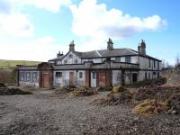 The former Dalmellington Iron Co Company Store, latterly a pub, adjacent to the station, photographed on 4 April 2010. Rail served at one time by a siding running along the nearside, there is now a pile of rotting sleepers at the end of the path.<br>
<br><br>[Colin Miller 04/04/2010]