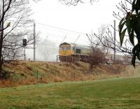 Early morning mist hangs over the WCML at Oubeck on 7 April as Freightliner 66621 waits in the Up Loop with an infrastructure train.<br><br>[Mark Bartlett 07/04/2010]