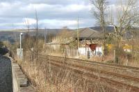 Looking north through the site of Chapel-en-le-Frith (Midland) station on 21 March 2010. The platforms have gone but the main station building on the up side remains and is now in use as Chapel DIY. On the down side a coal yard now goes right up to the trackside. The post with a camera to the left of the down line is presumably for the signaller at Chinley Junction to confirm that there is a tail-light on the rear vehicle for any train heading east and not passing the signalbox.<br><br>[John McIntyre 21/03/2010]