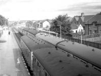 Crossing at Nairn station on 5th September 1970 with the 14:35 Inverness - Aberdeen at the near platform alongside <I>Scottish Grand Tour no 11</I> heading towards Inverness (with thanks to David Spaven). <br>
<br><br>[Bill Jamieson 05/09/1970]