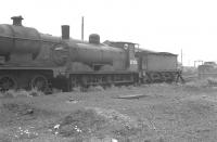 Stovepipe chimneyed Jumbo no 57353 on the scrap line at Hurlford in the summer of 1962, standing alongside a condemned class 2P.<br>
<br><br>[Colin Miller /08/1962]