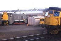 The private and public sector faces of the rail industry at Inverness in 1976. A Howard Doris shunting locomotive waits to be hauled west to Stromeferry sidings, while a Class 26 stands in the Platform 5 road on the north side of the station, with Lochgorm works in the background.<br><br>[Frank Spaven Collection (Courtesy David Spaven) //1976]