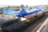 EWS 66030 with northbound coal empties passing Sanquhar on 3 March 2010. Restoration and refurbishmnet work on the station building is now well underway. [Editors Note: The building was purchased in 2008 by Peter Rushton [see image 23565] who has plans to turn it into a holiday let. He has kindly supplied the website with a number of photographs showing progress on the project.]<br><br>[Peter Rushton 03/03/2010]