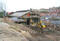 Refurbishment work being carried out on the former 50G Whitby locomotive shed on 23 March 2010. The shed closed in 1959 and has been in use in recent years as a ship's chandler. The view is towards the coast with the line running past on the other side of the low wall. Whitby Abbey stands on the hill in the right background.<br><br>[John Furnevel 23/03/2010]