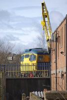 Privately preserved 26040 peeps out from a corner of Methil goods yard where it is stored along with a diesel crane, BR 20t brake van and some buses. Photographed on 27 March 2010. <br><br>[Bill Roberton 27/03/2010]