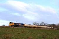 GBRf Class 66 No 66714 <I>Cromer Lifeboat</I> takes Alcan tanks north at Rhu on the West Highland Line on 9 April 2010. It will shortly pass the returning southbound tanks at Garelochhead around 19.30.<br><br>[John Robin 09/04/2010]