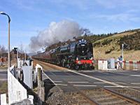 Britannia 70013 <I>Oliver Cromwell</I> chimes at Blackford level crossing on 11 April as it heads north with the <I>Great Britain</I> railtour.<br><br>[John Robin 11/04/2010]