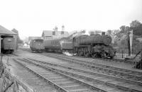 The 10.48 Saturday morning train to Carlisle pulls away from the platform at Langholm on 14 September 1963 with Ivatt 2-6-0 no 43045 in charge.<br><br>[Robin Barbour Collection (Courtesy Bruce McCartney) 14/09/1963]