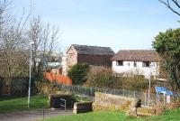 The tallish building in the centre of the picture was Maxwelltown Station and is now a house surrounded by more modern counterparts. The trackbed to Stranraer is in front of the red fence and forms part of a cyclepath/walkway to Castle Douglas.<br><br>[John Gray 10/04/2010]