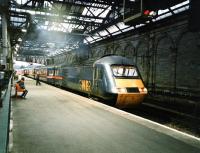 Back in the days when 125s made the right noise and smell, the Down 1632 Kings Cross - Inverness <I>Highland Chieftain</I> stands at platform 10 at Waverley. It is being watched by a man in an anorak, clearly not one to challenge stereotypes. Photographed in February 1998.<br>
<br>
<br><br>[David Panton /02/1998]