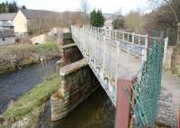 The first of the crossings of the Gala Water made by the Waverley route running north from Galashiels station lay between Plumtreehall Brae and Wheatlands Road on a bridge that has since been adapted for pedestrian use. The bridge, seen here looking north west on 11 April 2010, also marked the start of the gradual divergence of the Waverley and Peebles lines at Kilnknowe Junction. <br><br>[John Furnevel 11/04/2010]