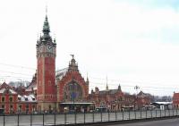 Facade of Gdansk Glowny in March 2010 - taken across a dual carriageway with a tram reservation in the middle. On the circular area is painted a copy of 'The Last Judgment' by Hans Memling, the original of which is in the Muzeum Narodowe in the city.<br>
<br><br>[Colin Miller 08/03/2010]