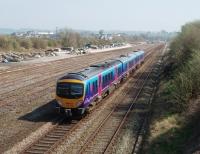 <I>From virtual quarry to virtually nothing</I>. TPE 185145 runs in to Carnforth from the Barrow line passing the sidings that were briefly an EWS virtual quarry, then engineers' sidings but which are now only used during local engineering works. Ahead of the unit is the curve into Carnforth station, the junction with the direct link that went straight ahead to the Wennington line having been removed some years ago. <br><br>[Mark Bartlett 17/04/2010]