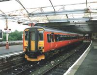 156 512 stands at bay platform 2 at Kilmarnock with a Burns Line service for Girvan in July 1997.  Happily the roof has since been reglazed with proper glass extending the whole length and the the ironwork has been repainted, making things looks a great deal smarter.<br><br>[David Panton /07/1997]