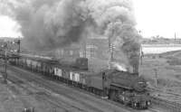 Ivatt 2-6-0 no 43049 heads out of Carlisle with a freight on the S&C route approaching Durranhill Junction in the 1960s. The Midland signal box is just off picture to the right while the box controlling the parallel NE route can be seen through the smoke. Off to the left of the picture stood the MR Durranhill shed, officially closed in November of 1959 and demolished in 1966. [see image 13849]. <br>
<br><br>[K A Gray 25/07/1966]