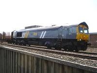 DRS operated <I>Fastline</I> liveried 66434 stands at signals north of Wrexham General on 22 April at the head of an empty Colas timber service returning from Kronospan at Chirk. The train is awaiting single line clearance to Saltney Junction, Chester. <br><br>[David Pesterfield 22/04/2010]