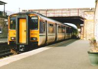 When National Express first had the ScotRail franchise after <br>
privatisation its colours were red blue and gold. It was never <br>
adopted as a livery though there was a trial on one ageing unit, 101 692 [see image 18845]. The colours were later changed to purple, dark green and sienna (or was it ochre?) which this time was taken up as a livery. Around 2002, unit 150 262 pulls into the up platform at Markinch after reversing at the north crossover for its return to Edinburgh.<br>
<br><br>[David Panton //2002]