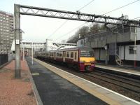 320 319 at Damuir with a Balloch to Airdrie via Singer service on 24 April 2010. Note the contrast between the new footbridge and the ageing Portakabins.<br><br>[David Panton 24/04/2010]