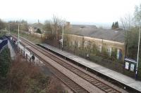 Burnley Manchester Road reopened in 1986, following the successful reintroduction of passenger trains on the Copy Pit line between Lancashire and West Yorkshire two years previously. This view, from the very long access ramp to Platform 1, looks towards Gannow Junction and Rose Grove and shows the new platforms alongside the original station building, closed in 1961 and no longer used by the railway.<br><br>[Mark Bartlett 24/04/2010]