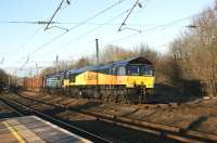 Colas Rail locomotive 66843 thunders south through Lancaster with the Carlisle - Chirk logs on 11 February 2010. DRS 57002 is DIT as insurance.<br><br>[John McIntyre 11/02/2010]