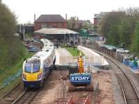 Significant building work at Poulton has seen the very long island platform drastically shortened and refurbished. Because the area under the canopy is also under renovation it is also fenced off leaving only a limited area for trains to use. Northern Adelante 180103 calls on a Manchester to Blackpool service on 27 April but only four of its five coaches fit the available area of platform. View towards Blackpool. <br><br>[Mark Bartlett 27/04/2010]