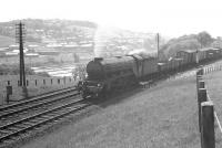 A freight climbs north out of Hawick on 8 June 1962. The locomotive is Canal A3 Pacific no 60068 <I>Sir Visto</I> and the train the 11.35am Carlisle - Craiginches. At the bottom of the hill in front of the train lies part of the town's sewage works.<br><br>[K A Gray 08/06/1962]