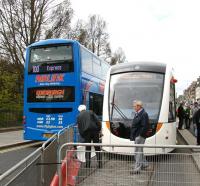 <I>'There goes the competition!'</I> The current favoured method of reaching Edinburgh airport by public transport from the city centre passes a would-be future method on Princes Street on 29 April 2010. <br><br>[John Furnevel 29/04/2010]