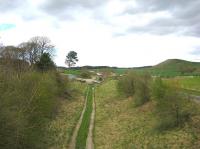 Looking north along the trackbed of the Waverley route towards the former Hassendean station on 26 April 2010 with the old station building and footbridge visible in the distance. <br><br>[Bruce McCartney 26/04/2010]