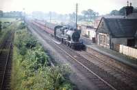 40574 takes a train through Lochside station bound for Glasgow in the summer of 1959. The station had been closed to passenger traffic 4 years earler but was subsequently reopened in 1966. The name Lochside was changed to Lochwinnoch in May 1985.<br><br>[A Snapper (Courtesy Bruce McCartney) 21/08/1959]