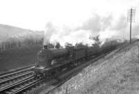 D30 <I>Scott</I> class 4-4-0 no 62428 <I>The Talisman</I> takes a northbound stopping train away from Hawick on the Waverley route in the summer of 1958. Having spent all its post-nationalisation years at Hawick shed, the locomotive was finally withdrawn from there some 4 months after this photograph was taken. [See image 24437]<br><br>[Robin Barbour Collection (Courtesy Bruce McCartney) 05/08/1958]