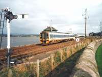 High Tide in Montrose Basin in October 1998 which, disorientatingly for strangers, gives the impression that the sea is on the wrong side.158 741 passes Montrose South signal box with a southbound service and is entering the short single track section to Usan.<br><br>[David Panton /10/1998]