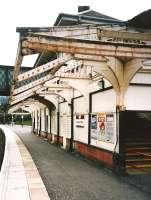 Maxwell Park in March 1998 and the glazing had been removed from the <br>
canopies, which I suppose was one way of solving a maintenance problem. Happily this unstaffed station went on to undergo an award-winning restoration [see image 7459] and is a credit even to one of Glasgow's smarter suburbs.  It's never too difficult to guess which passengers are going to alight here.<br><br>[David Panton /03/1998]