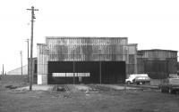 The abandoned 64F Bathgate shed, by then trackless, seen in February 1970, three and a half years after official closure. The old shed was sold off by BR shortly afterwards and continued in use for another 40 years or so, initially as a garage and latterly as a building maintenance company. The structure was eventually demolished in September 2009 as part of a major redevelopment of the area in connection with construction of the new Bathgate station [see image 25412].<br>
<br><br>[Bill Jamieson /02/1970]