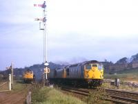 Two BRCW Types 2s leaving Burntisland with an Aberdeen - Edinburgh express in the summer of 1971, while another shunts freight traffic in the sidings.<br>
<br><br>[David Spaven //1971]