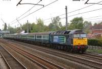 The second of two football specials from Barrow in Furness to Wembley on 8 May 2010, taking Barrow FC supporters to the FA Trophy final. The first train was operated by DBS and the second by DRS, with 47501 on the front and 47712 at the rear. The special is seeen here approaching Euxton Balshaw Lane on the Up Fast line.<br>
<br><br>[John McIntyre 08/05/2010]