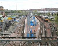 Scene at Airdrie on 2 May looking towards Bathgate, with a westbound service from Drumgelloch entering the station in the left background. Clearance work has been completed on the north side of the line and construction of the second through platform is currently underway.<br><br>[John Furnevel 02/05/2010]